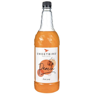 Bottle of Sweetbird peach fruit syrup on a white background